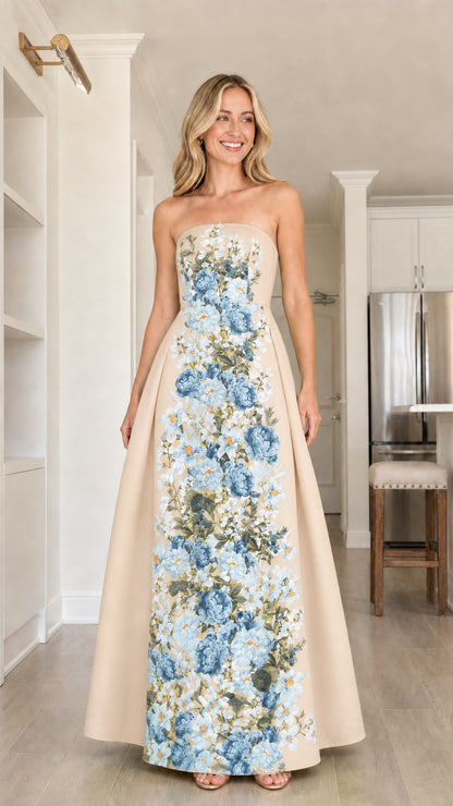 Front view of model in champagne floral strapless maxi dress