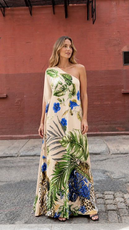 Model wearing beige tropical print one-shoulder maxi dress