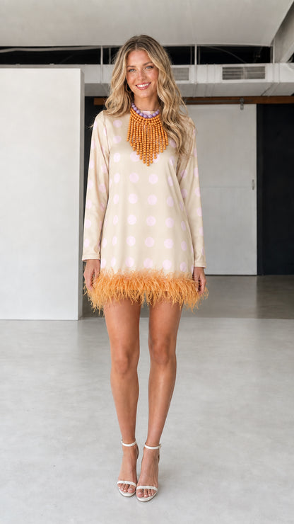 Model wearing beige polka dot feather hem dress
