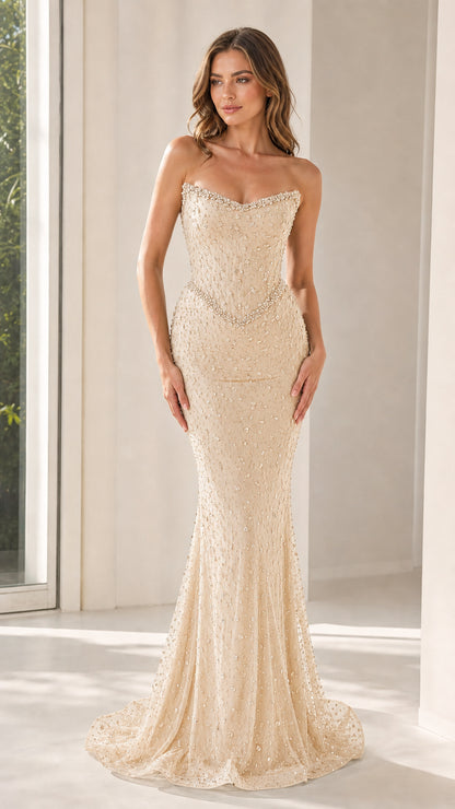 Front view of champagne strapless beaded mermaid evening gown
