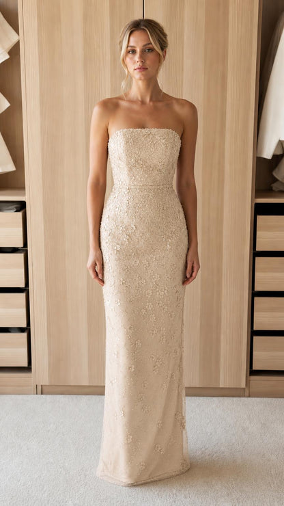 Front view of model wearing champagne strapless evening gown