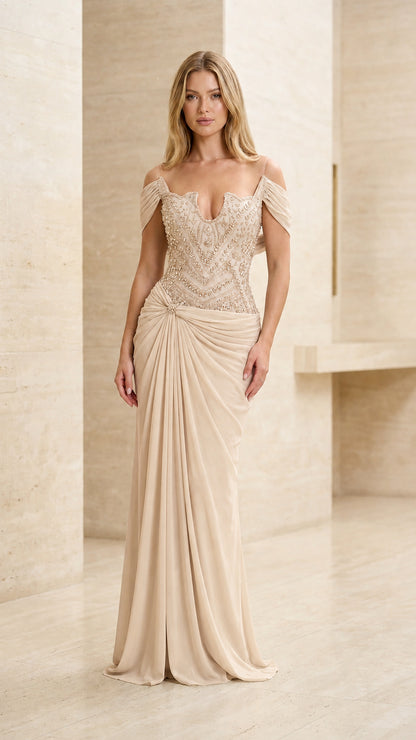 Model wearing champagne gold beaded off-the-shoulder evening dress