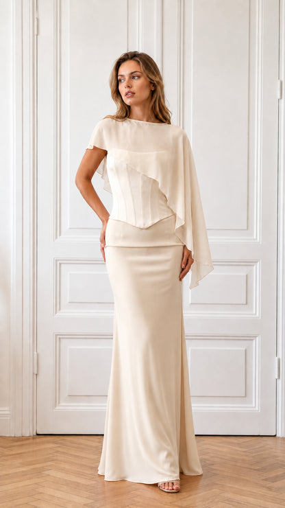 Model wearing champagne formal cape evening dress