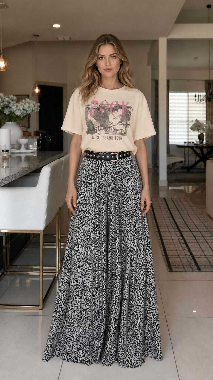 Model wearing beige graphic tee and leopard print pants