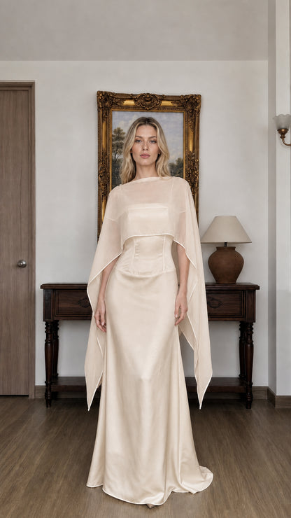 Front view of woman wearing champagne cape overlay evening dress
