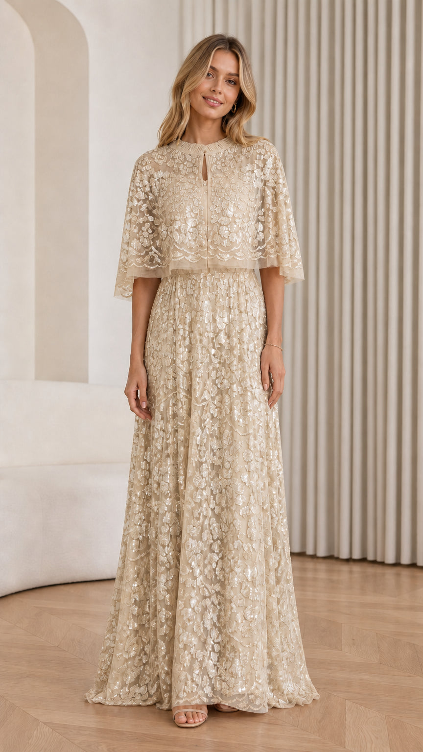 Front view of Champagne sequin cape maxi dress on model