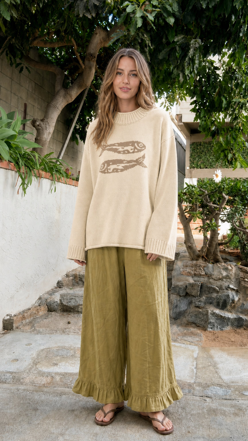 Front view of model wearing Cream beige fish motif oversized knit sweater