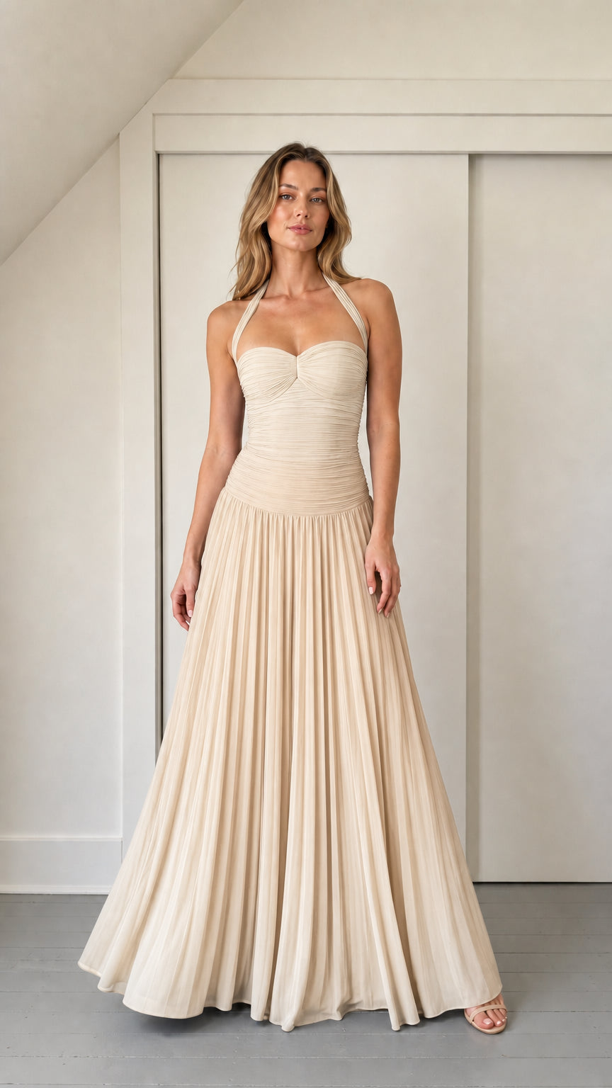 Model wearing champagne ruched halter maxi dress