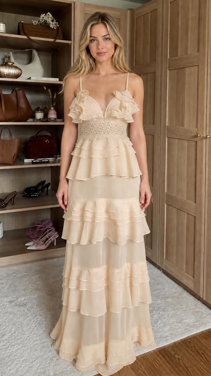 Front view of model wearing champagne ruffled tiered maxi dress