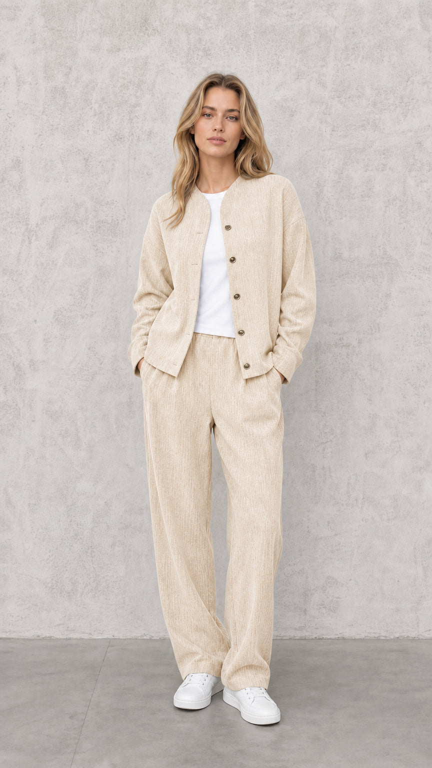Model wearing Cream neutral textured two-piece lounge jacket and pant set