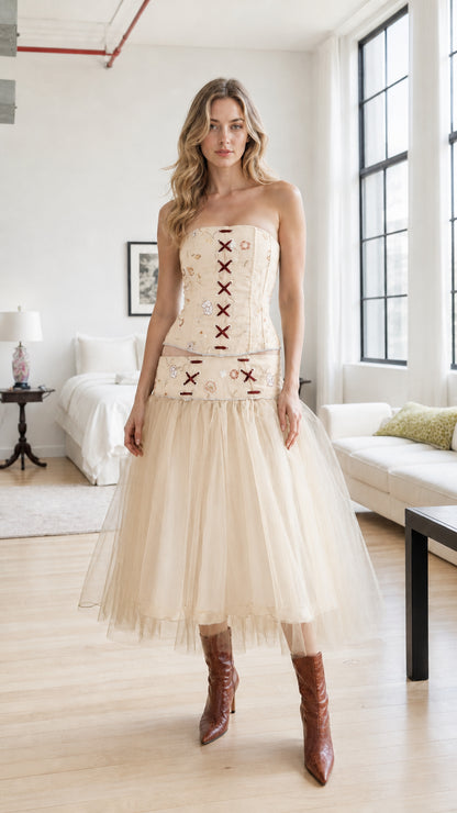 Model wearing champagne embroidered corset and tulle skirt set