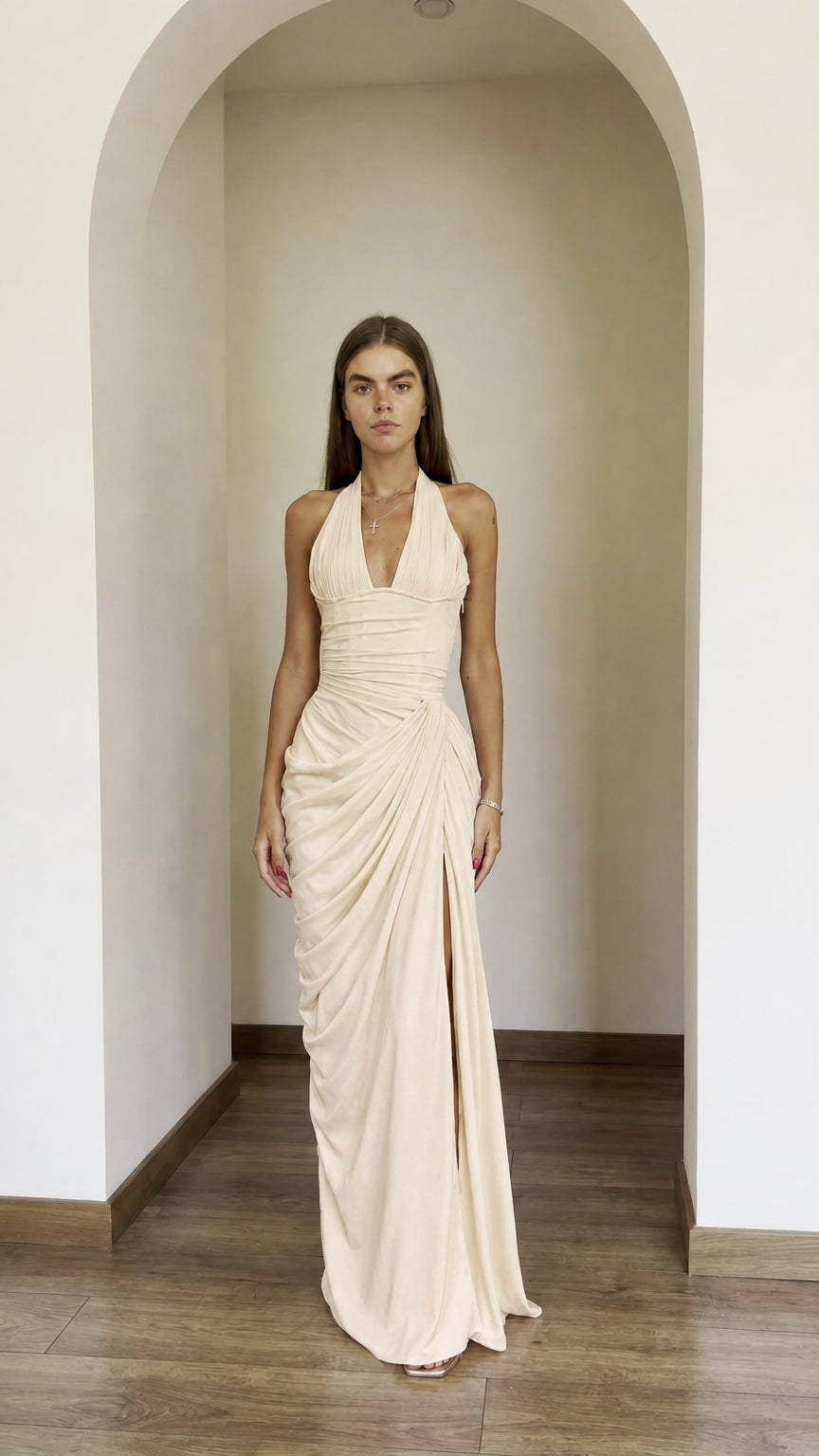 Front view of model wearing champagne halter ruched maxi dress