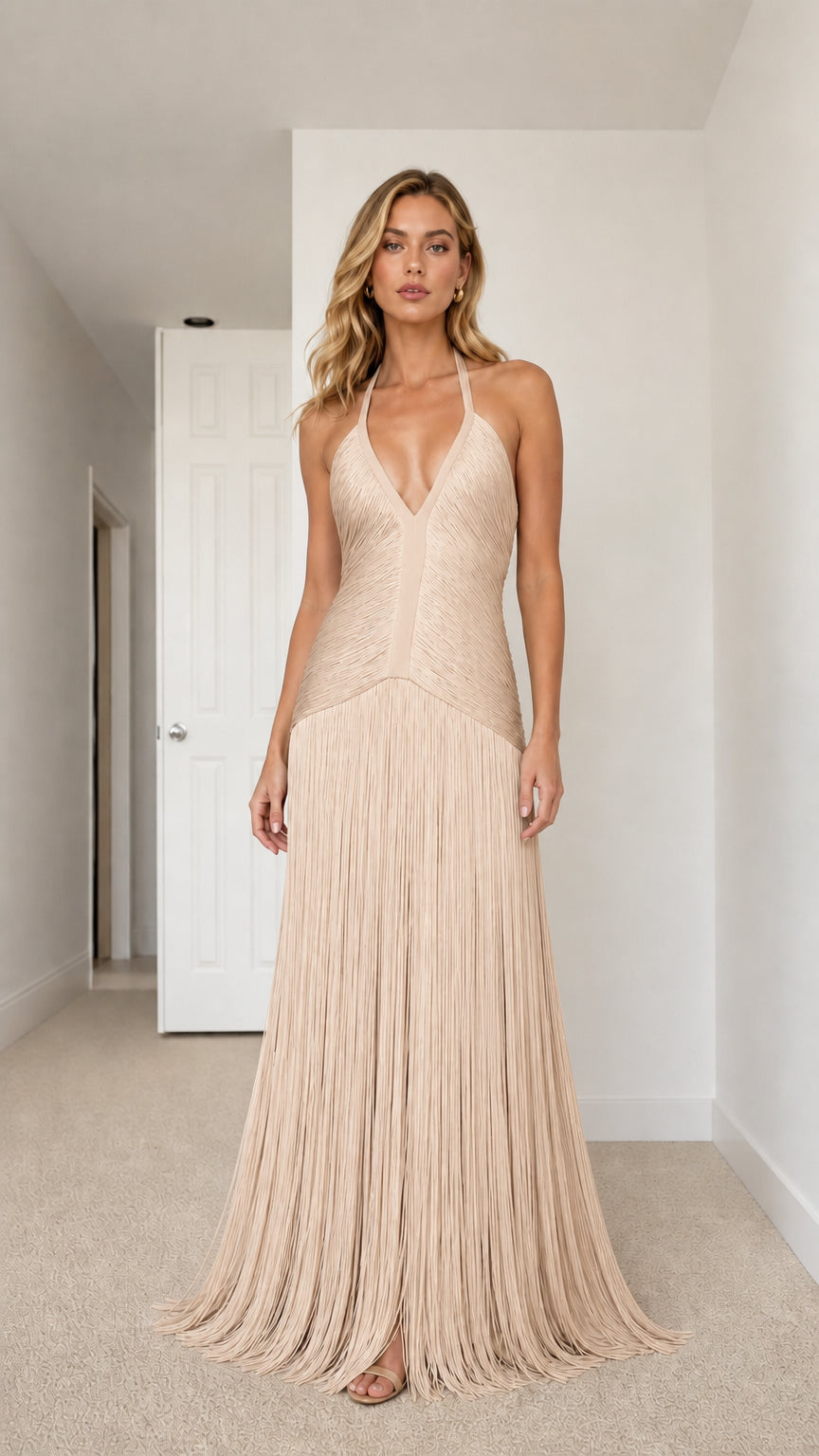 Model wearing champagne nude halter plunge fringe floor-length gown
