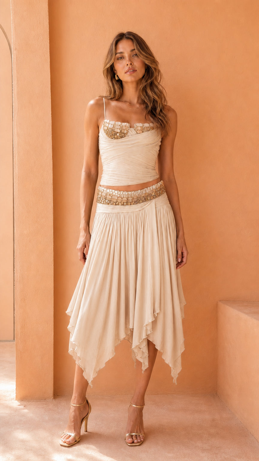 Model wearing ivory embellished corset top and skirt set