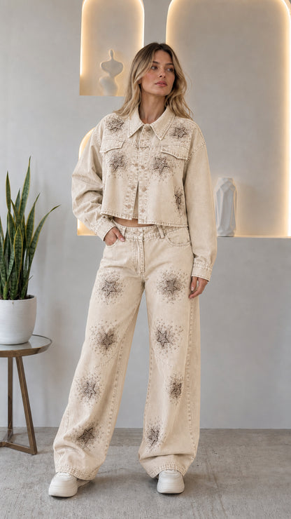 Woman wearing cream off-white rhinestone star cropped denim jacket and wide leg jeans two-piece set