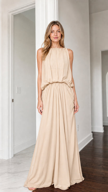 Front view of woman wearing beige cream sleeveless high neck maxi dress