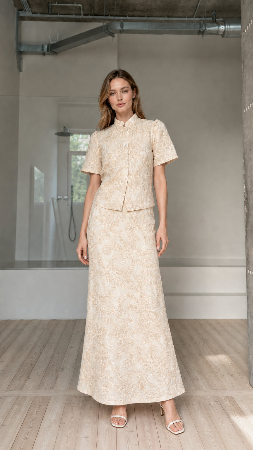 Model wearing beige cream floral embroidered short-sleeve top and maxi skirt set