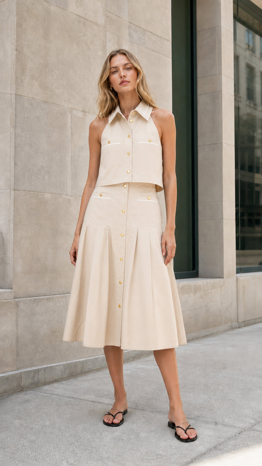 Ivory sleeveless collared top and pleated midi skirt set shown from the front