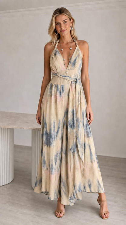Model wearing beige tie-dye halter neck maxi jumpsuit