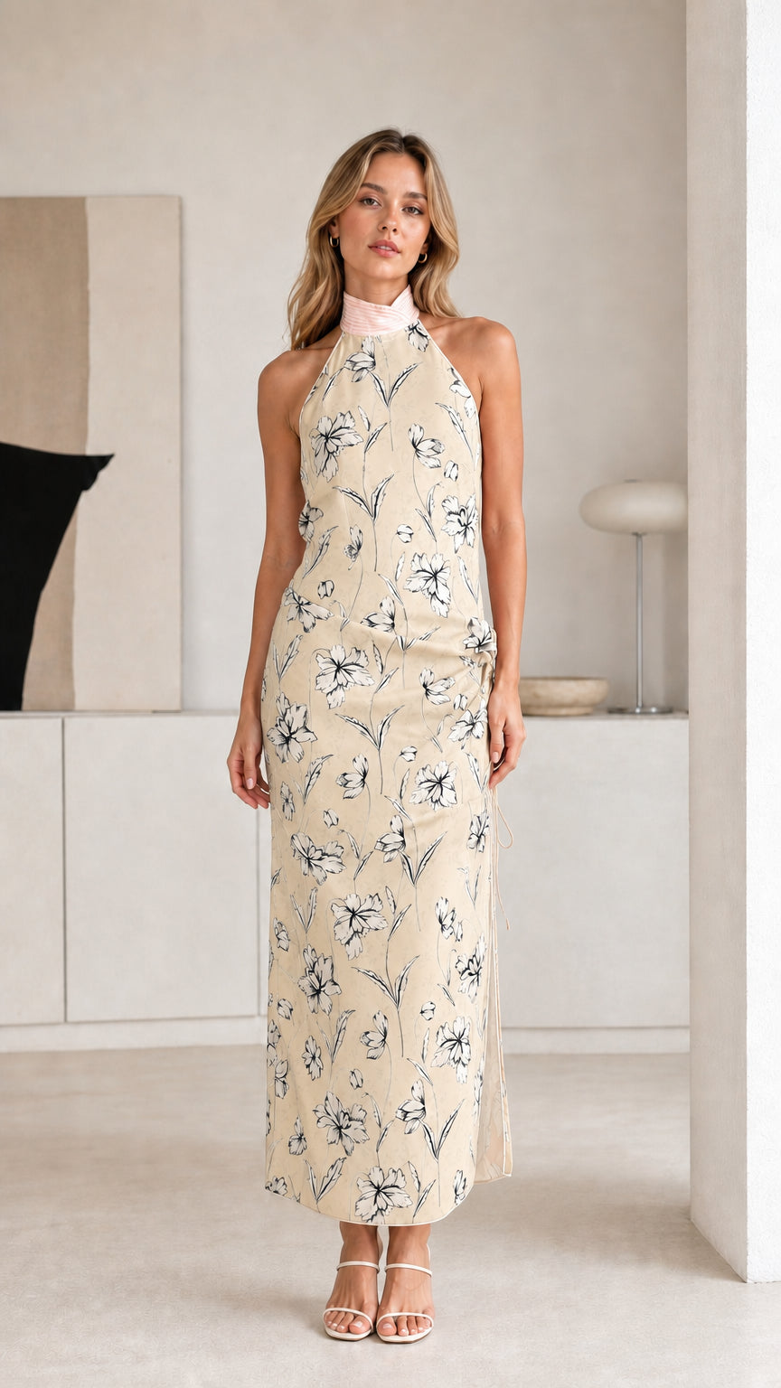 Woman wearing beige floral halter maxi dress
