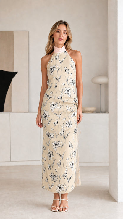 Woman wearing beige floral halter maxi dress