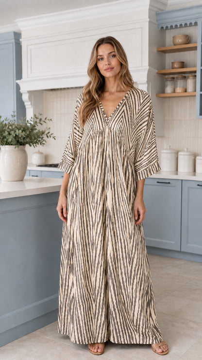Front view of woman wearing Cream beige printed flowy maxi jumpsuit