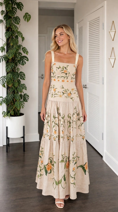Front view of model wearing beige floral embroidered tiered maxi dress