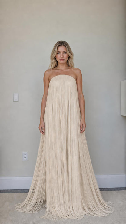 Front view of champagne strapless fringe maxi dress