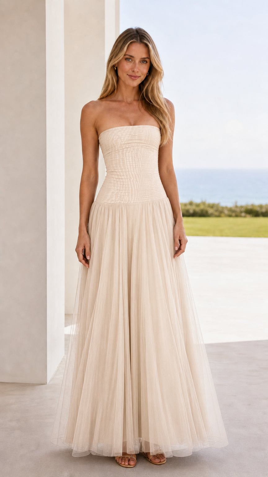 Front view of champagne strapless ruched tulle maxi dress