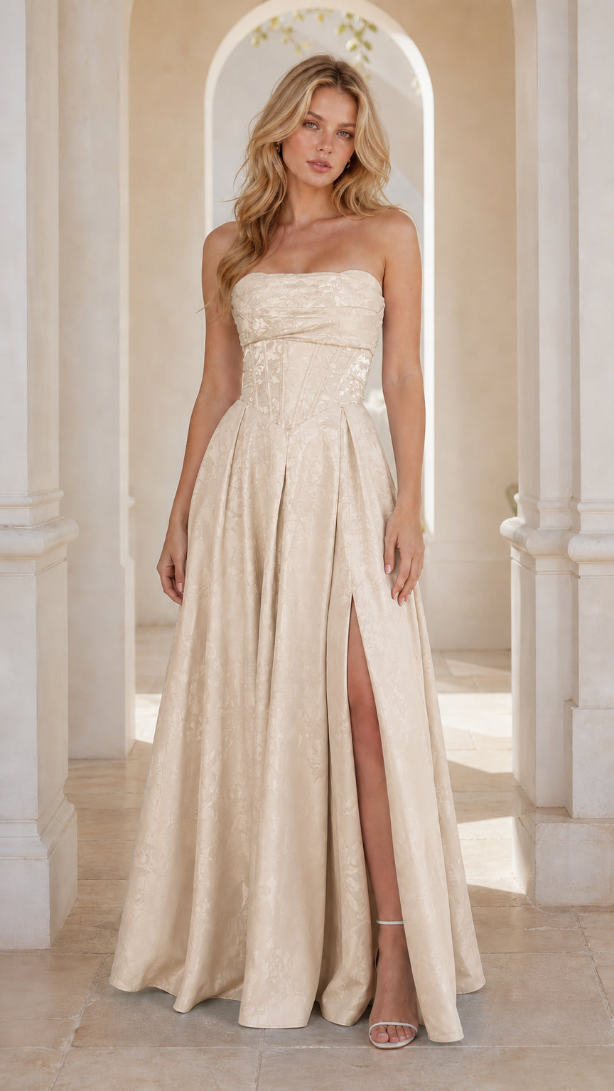 Model wearing champagne ivory strapless jacquard formal gown