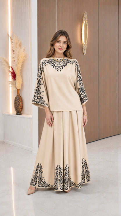 Model wearing Beige two-piece blouse and maxi skirt set with black floral pattern
