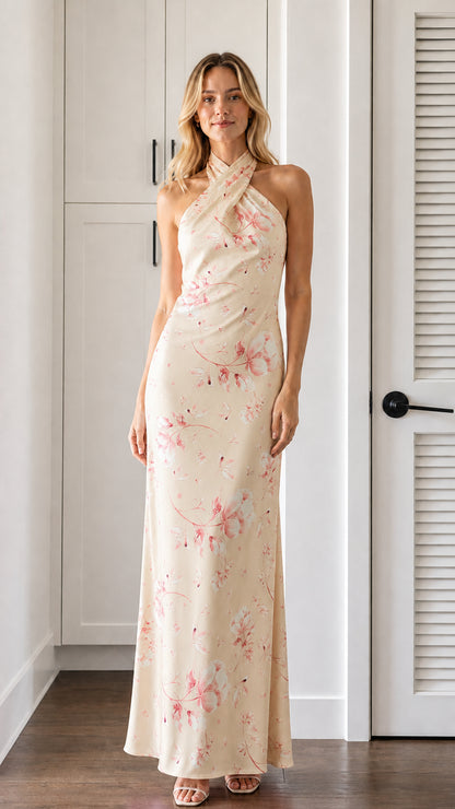 Front view of model wearing cream floral halter neck maxi dress
