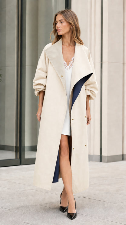 Model wearing cream off-white long duster coat with navy contrast accents