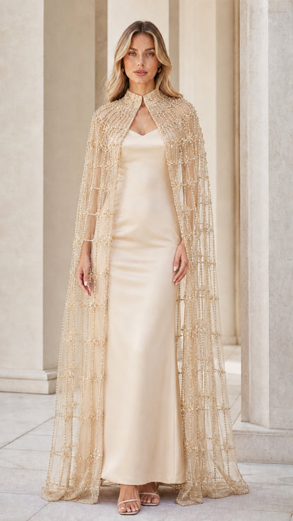 Model wearing champagne beaded cape and matching evening gown