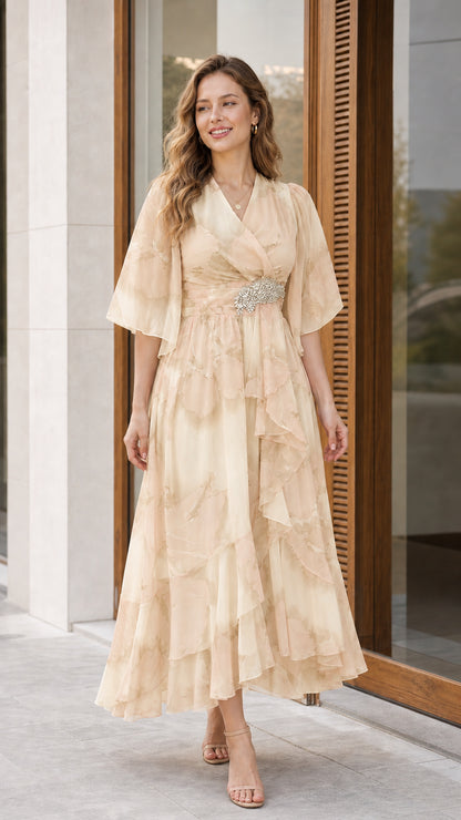 Woman wearing champagne beige floral chiffon flutter sleeve midi dress