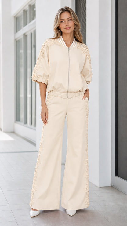 Front view of women's cream beige lace detail bomber jacket and wide-leg pant set