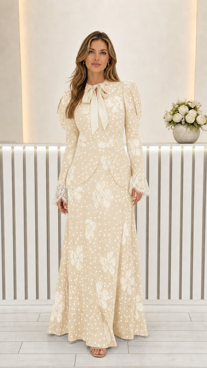 Front view of beige cream floral polka dot long sleeve maxi dress with contrast bow