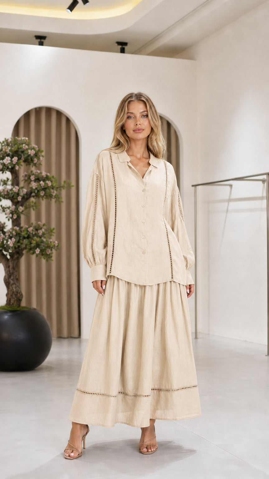 Front view of the cream women's blouse and maxi skirt two-piece set