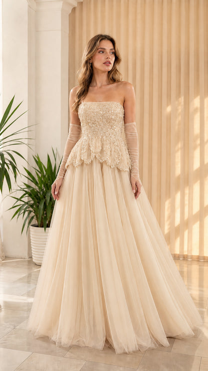 Full-length front view of champagne cream strapless beaded peplum tulle formal dress