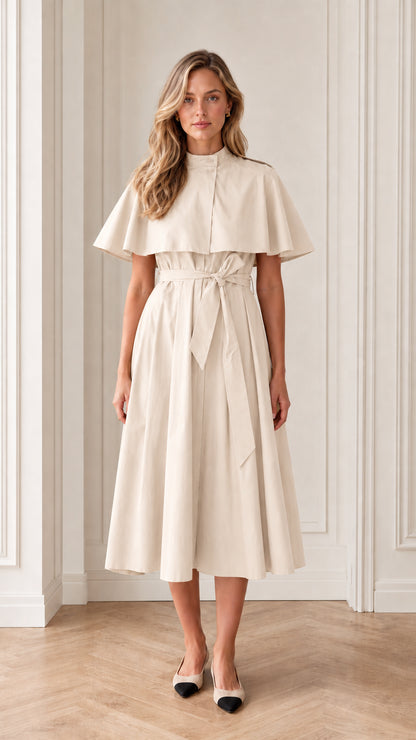 Model wearing cream off-white trench capelet belted midi dress