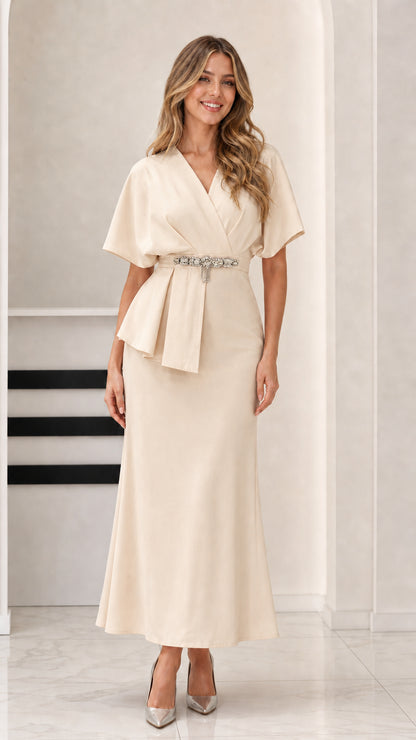 Model wearing soft Champagne neutral peplum formal maxi dress