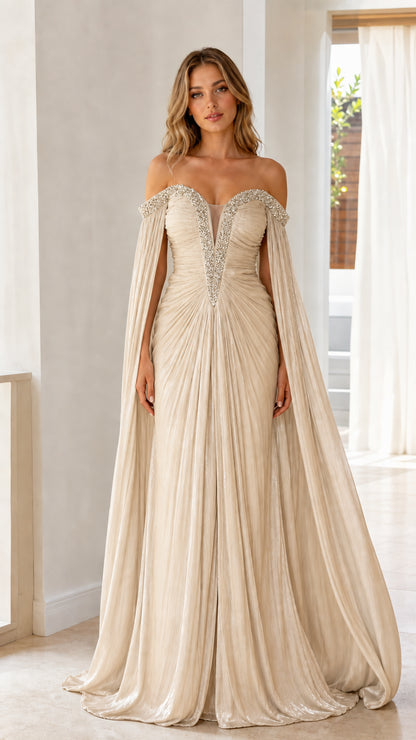 Front view of model wearing champagne gold off-the-shoulder cape sleeve pleated evening gown