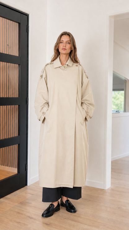 Front full view of woman wearing beige cream oversized maxi trench coat