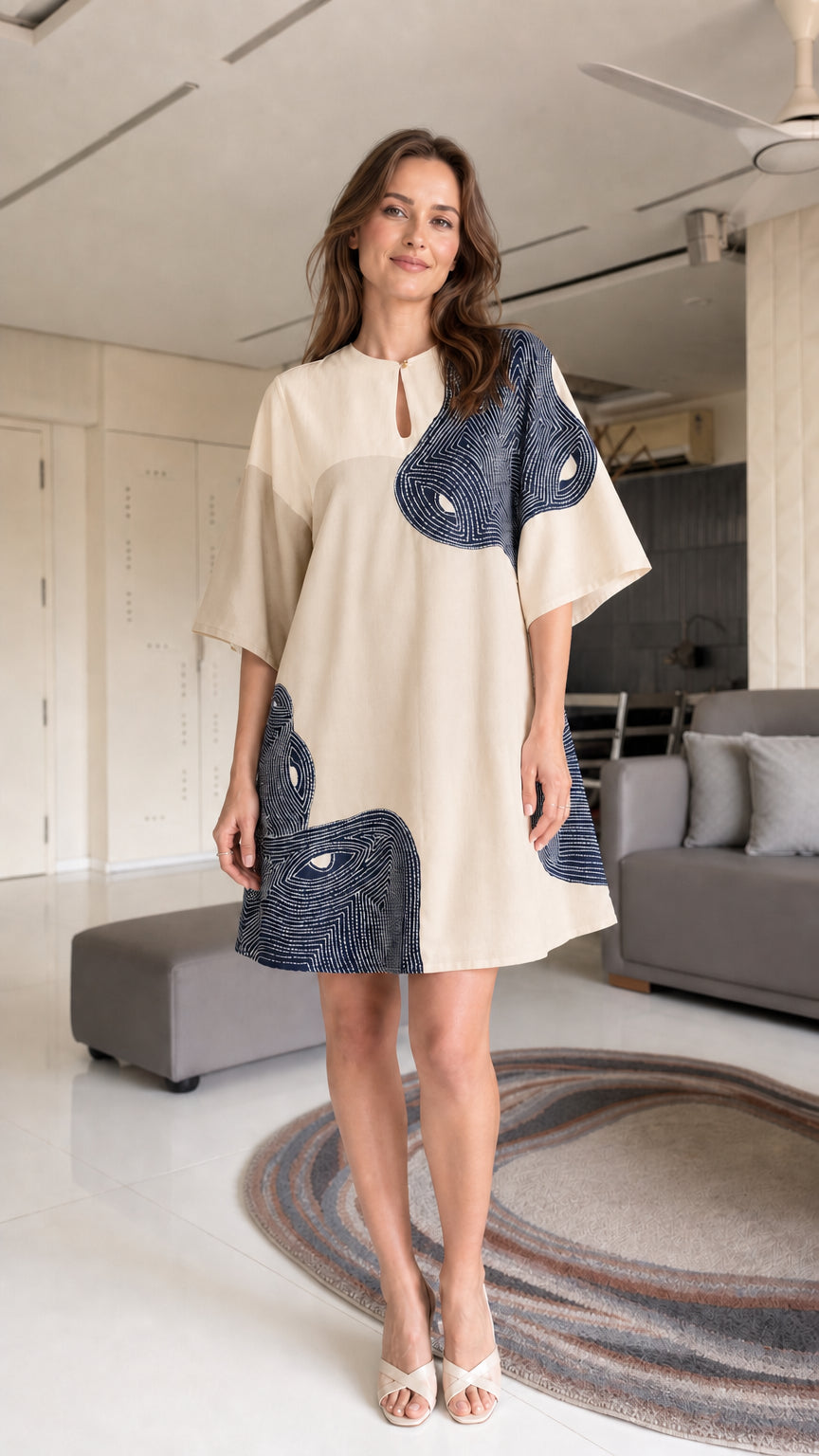 Model wearing beige and navy shift dress
