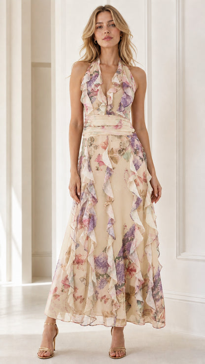 Front view of model wearing champagne floral halter ruffle maxi dress