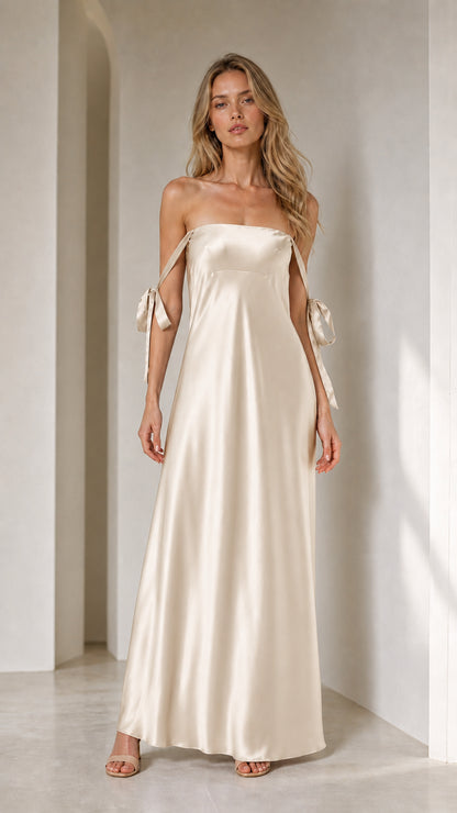 Model wearing champagne satin strapless maxi dress