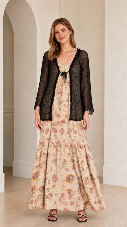 Front view of the cream floral maxi dress with sheer black cardigan overlay