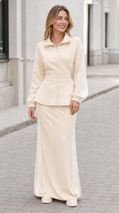 Woman wearing cream beige zip-up top and matching striped maxi skirt set