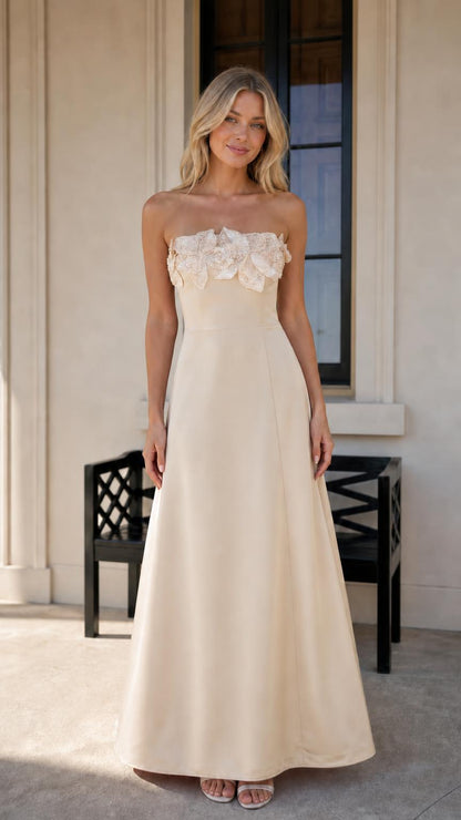 Model wearing champagne evening dress with floral bodice