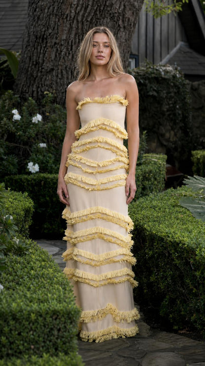 Model wearing champagne tiered fringe strapless maxi dress